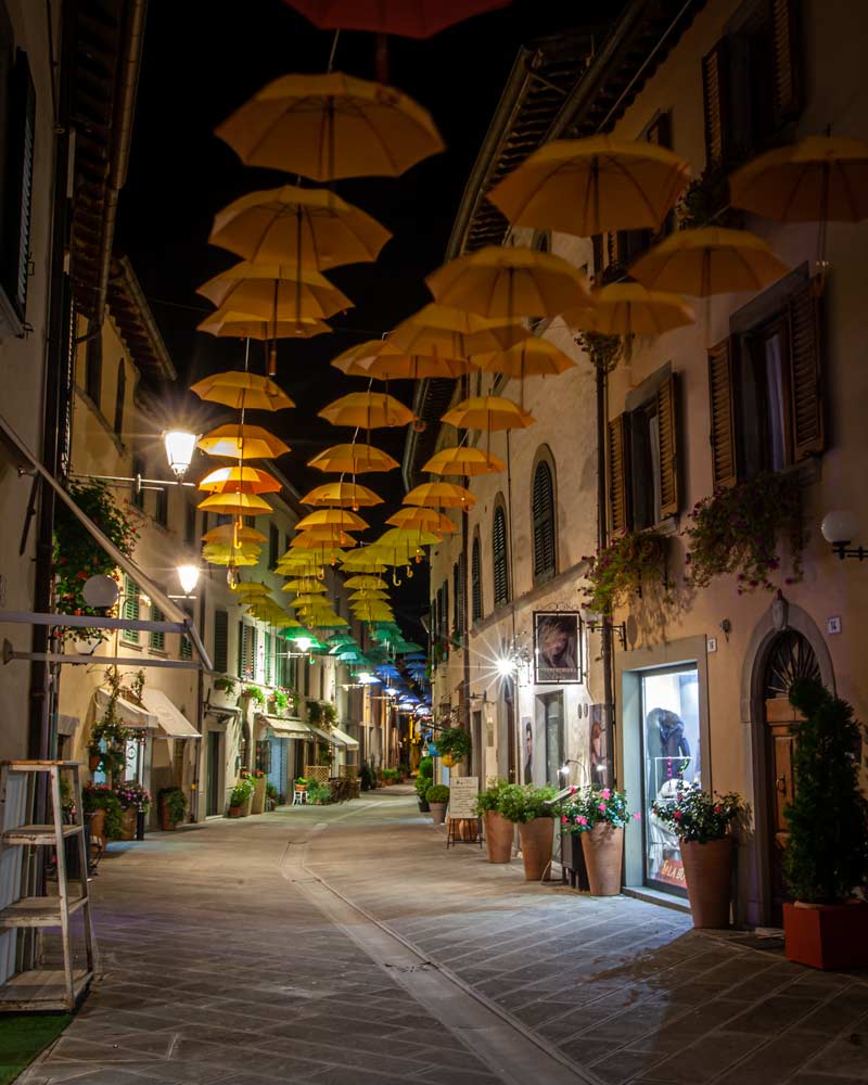 Bagno di Romagna by night with umbrellas hanging in a street
