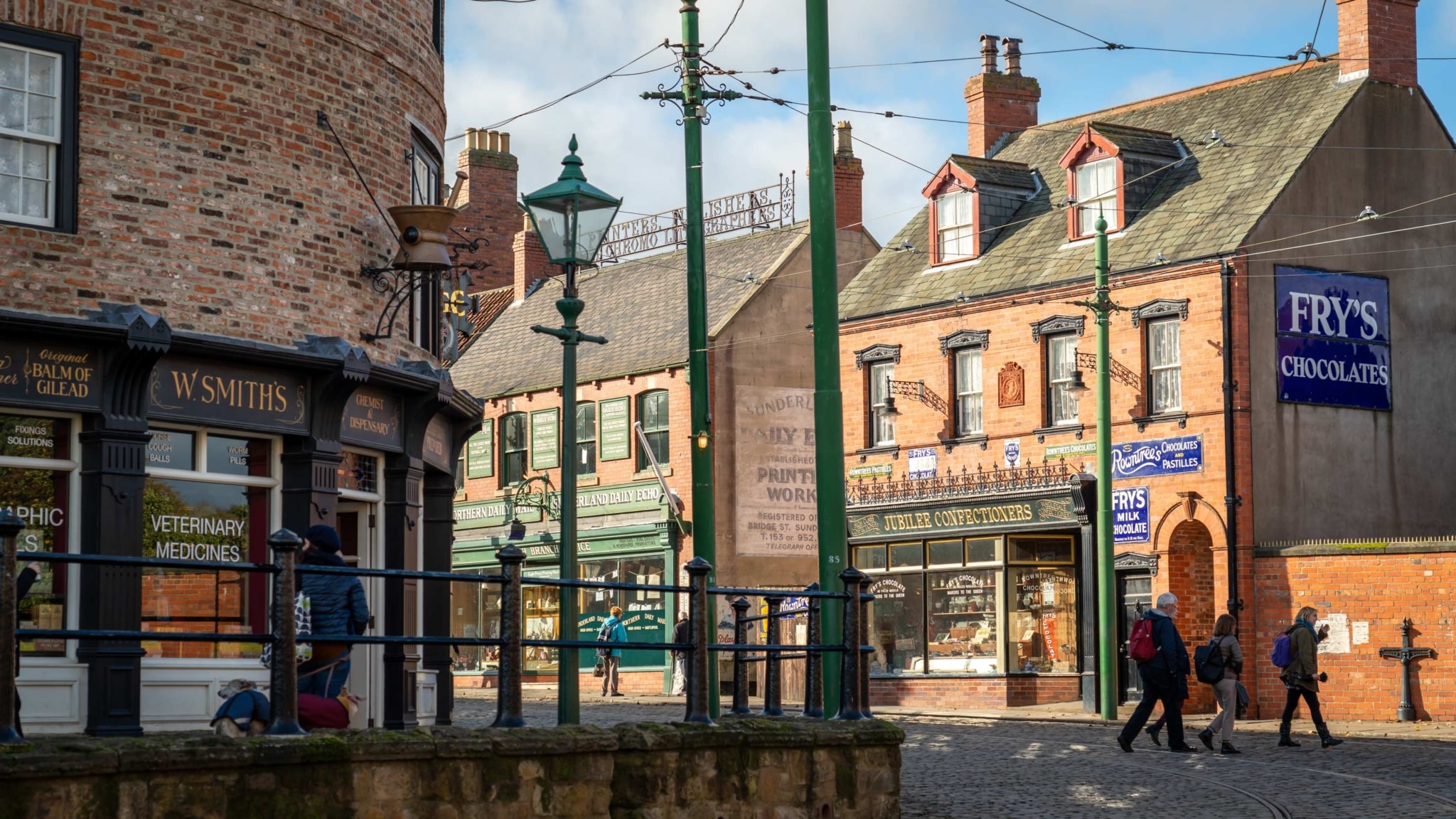 A street in Beamish Museum, with old fashioned shops and tram rails