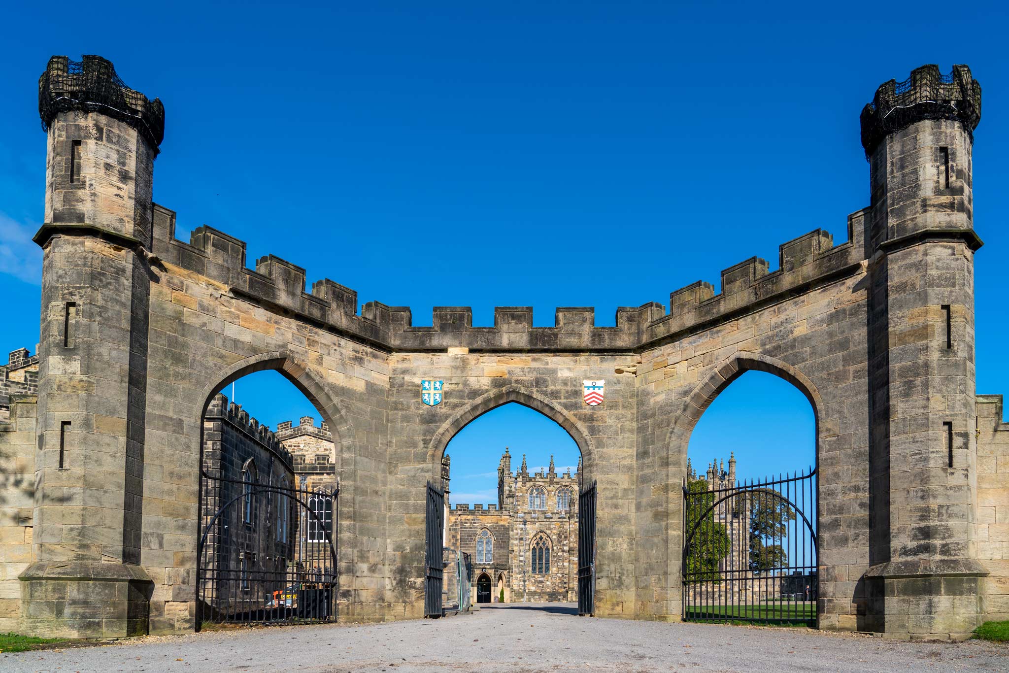 The imposing entrance to Auckland Castle made out of stone arches