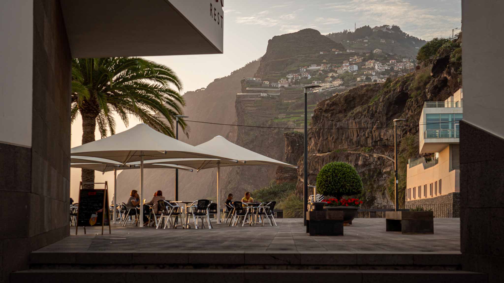 View from a restaurant in Camara do Lobos of a sea cliff at sunset