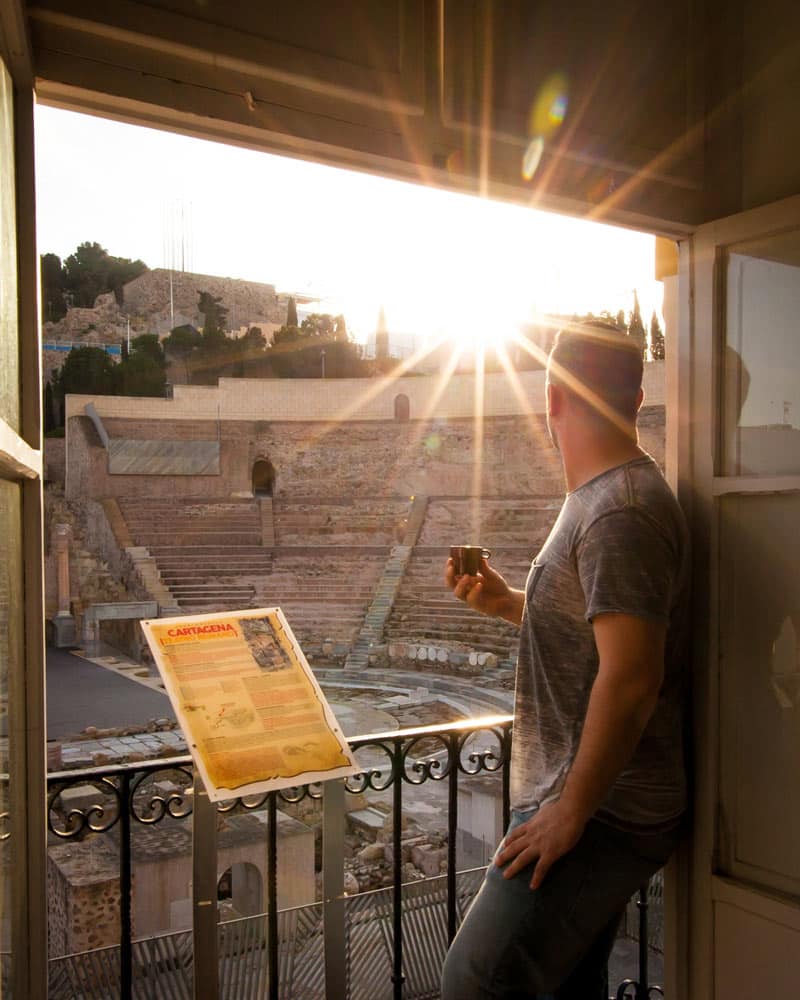 Dan in the window of an apartment looking out on the Roman Theatre