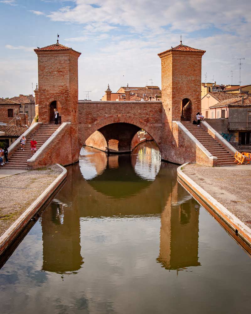 A bridge in Comacchio reflected in the water
