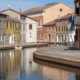Canals reflects colourful houses in Comacchio