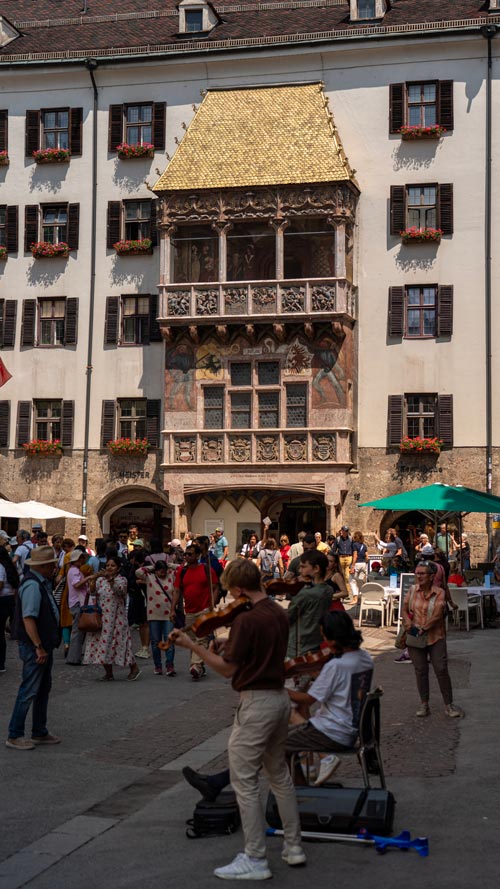 Innsbruck's Golden Roof with gilded copper is atop a pillared building with paiting