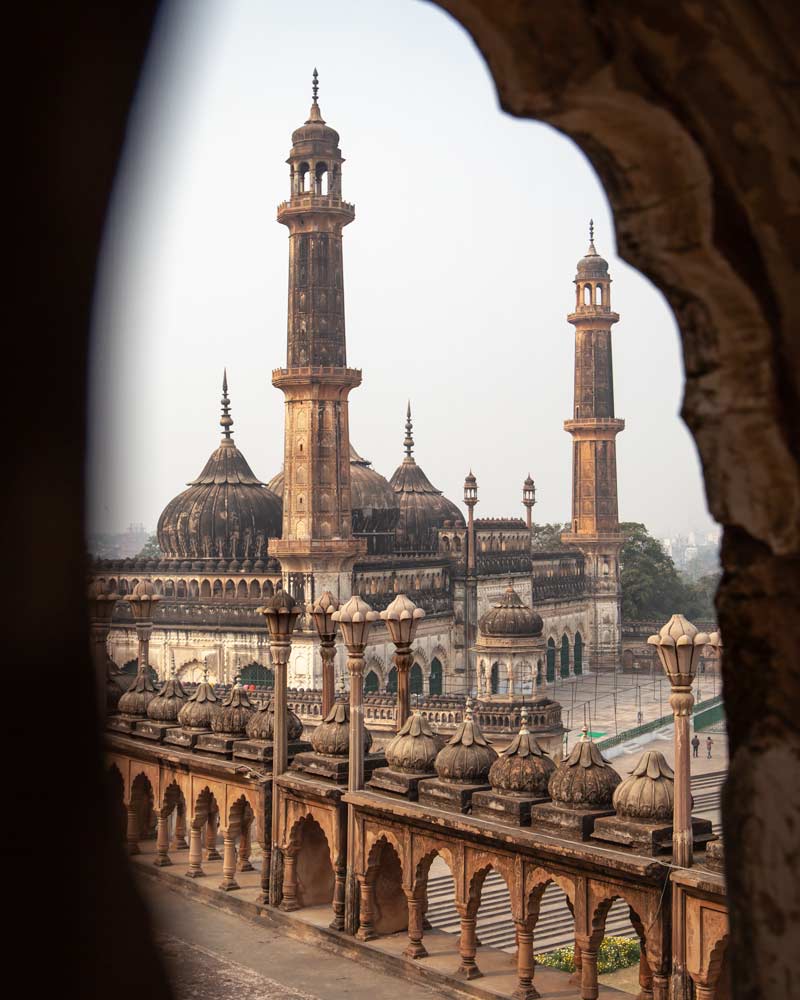 The Bara Imambara mosque with three minarets as seen through a window