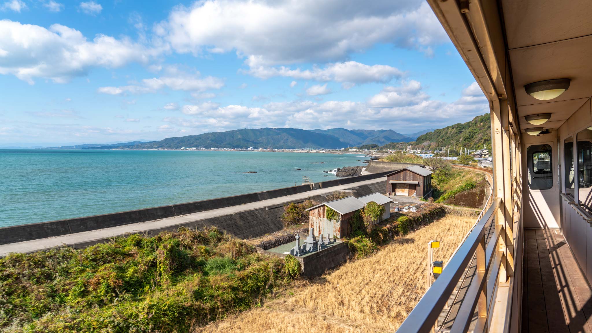 An open sided train in Kochi, Japan, looks out to the ocean