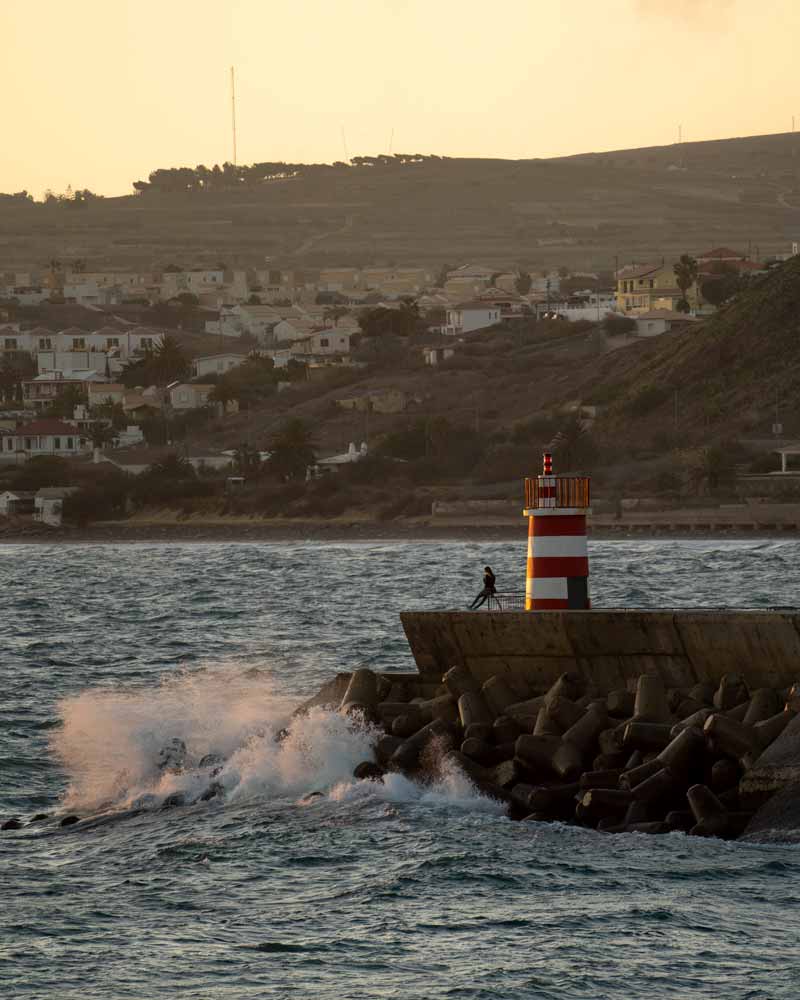 Sunset at the Porto Santo lighthouse with crashing waves