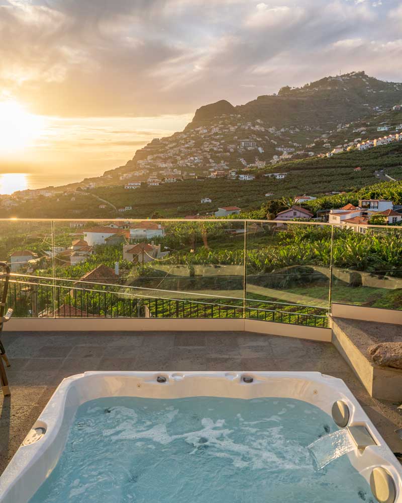 The hot tub looking out at green mountains in Madeira at Quinta da Saraiba