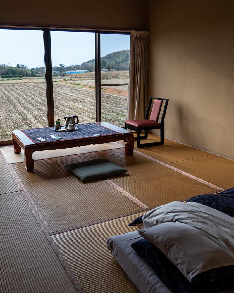 A traditional Japanese bedroom with a futon on the floor