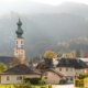 Beautiful mountain and lake views await in Saint Gilgen where a church spire stands infront of a towering mountain